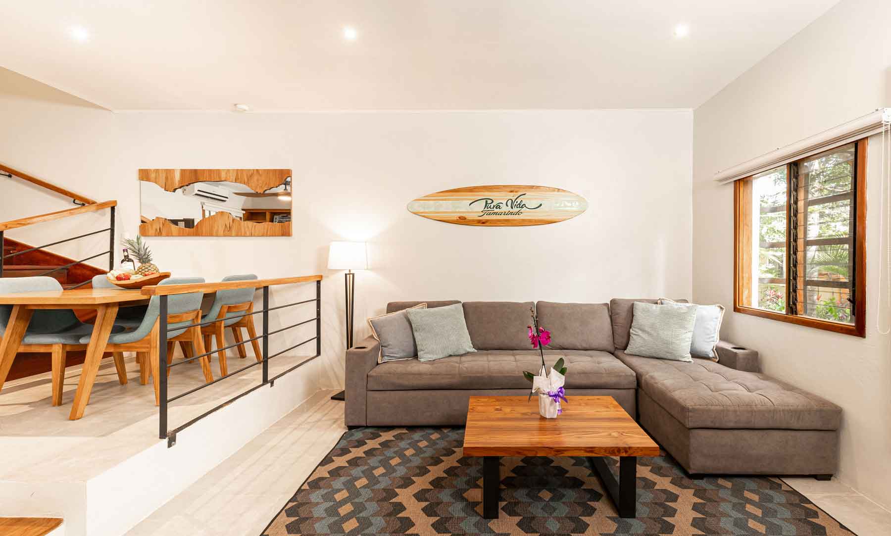 Pueblo del Mar 21 living room with sectional sofa and open dining area, furnished investment property in Tamarindo