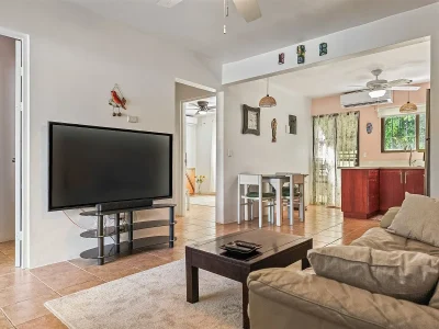 Tropical Waves 5 Playas del Coco open living area with kitchen and dining space in Las Palmas condo near beach