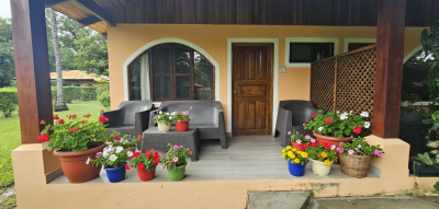Front porch seating area at Villagio 1 Unit 25, a walk to beach condo Playa Potrero with outdoor living space