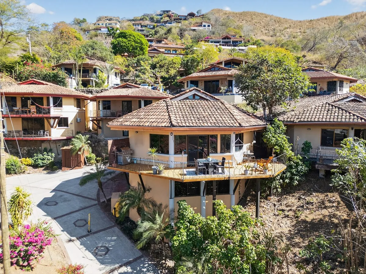 Villa Mango aerial view of gated community home in Playa Hermosa with wraparound deck and hillside setting