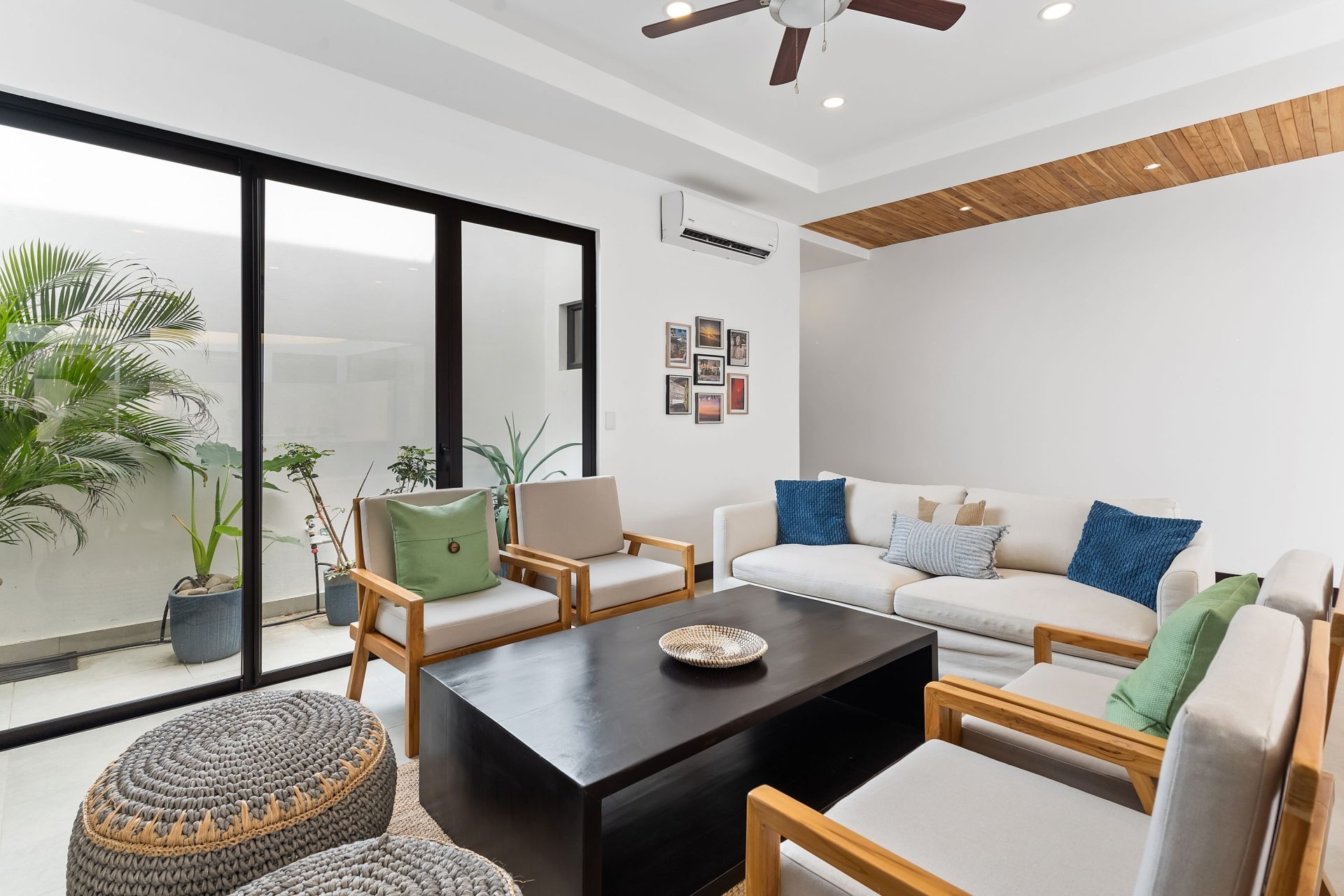 Tamarindo Walk living room with modern seating, courtyard windows, new construction home in Tamarindo Costa Rica