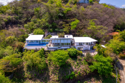 Casa Holmes Playas del Coco hillside glass home with infinity pool and panoramic views of ocean and tropical forest