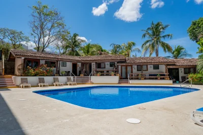 Paradise Condo 9 Tamarindo pool area with tropical landscaping and Tamarindo poolside condo setting