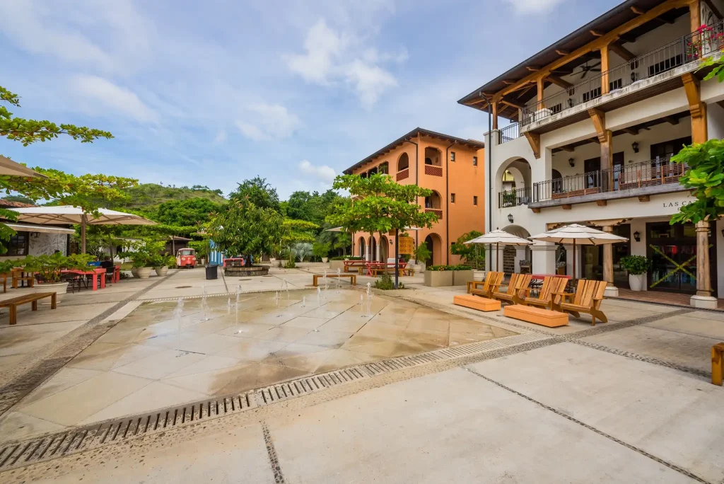 Car-free plaza with a splash fountain, café seating and colonial-style buildings in Las Catalinas, Guanacaste, Costa Rica