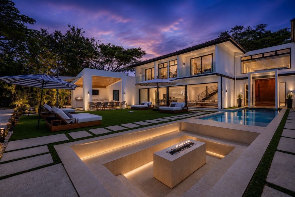 Casa Blanca illuminated at twilight with pool, outdoor lounge, and golf course estate setting in Hacienda Pinilla