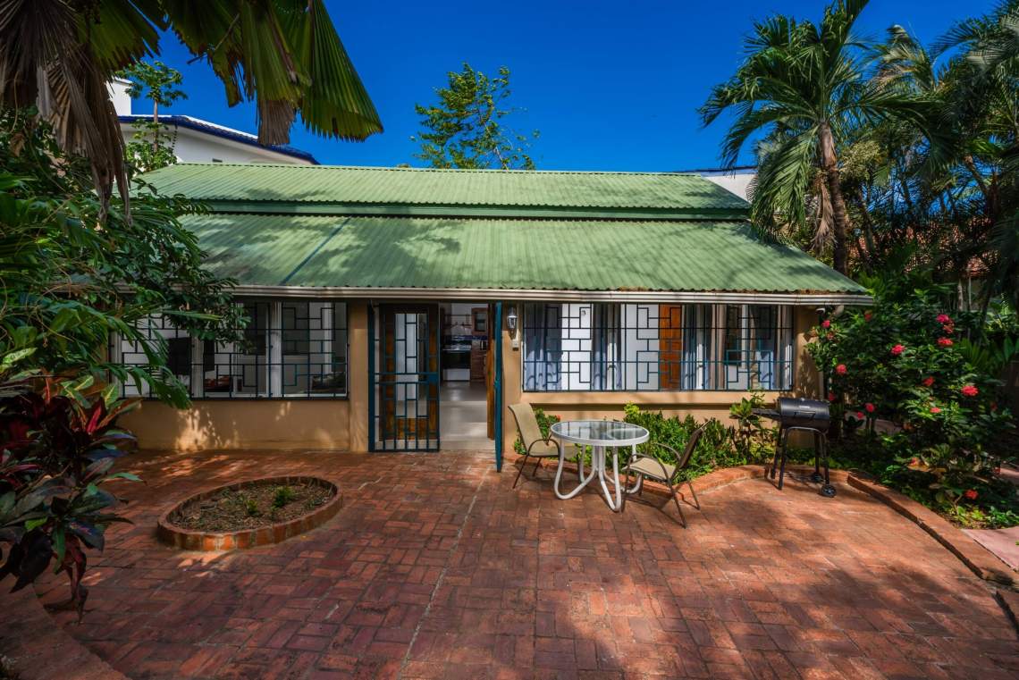 Front exterior of Casa Luna with landscaped courtyard in Playa Langosta.