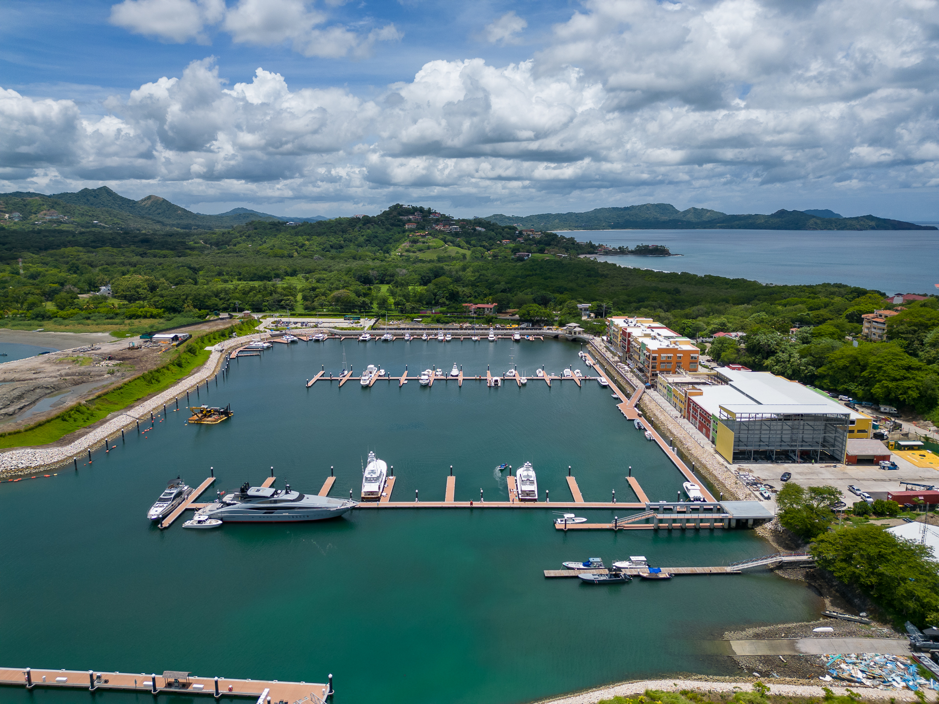 Aerial view of Marina Flamingo with yachts at the docks and hillside homes above Playa Flamingo, Guanacaste, Costa Rica