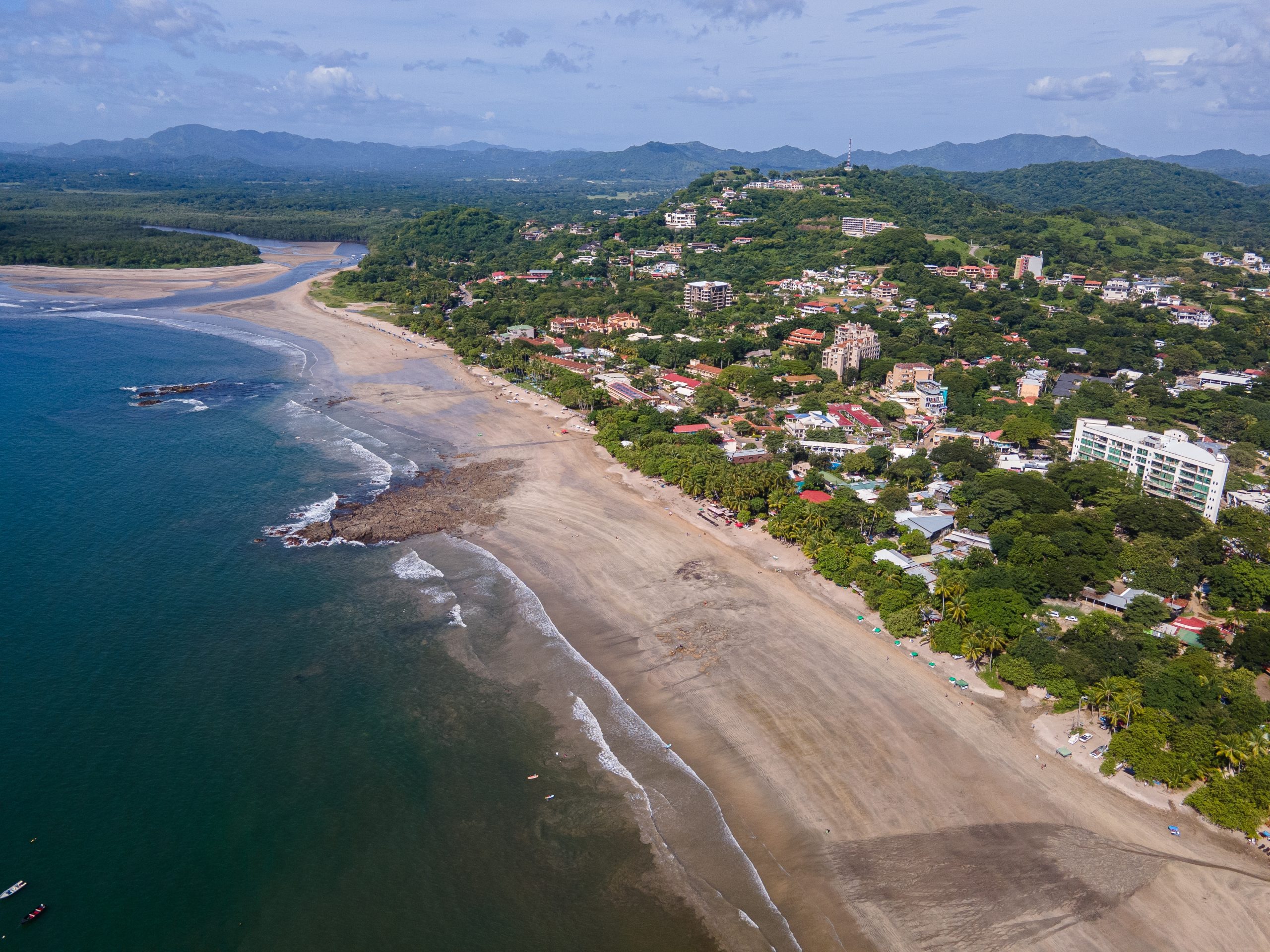 Aerial photo of the busy Tamarindo beach town center in Guanacaste, showing the coastal density some buyers prefer to live outside of