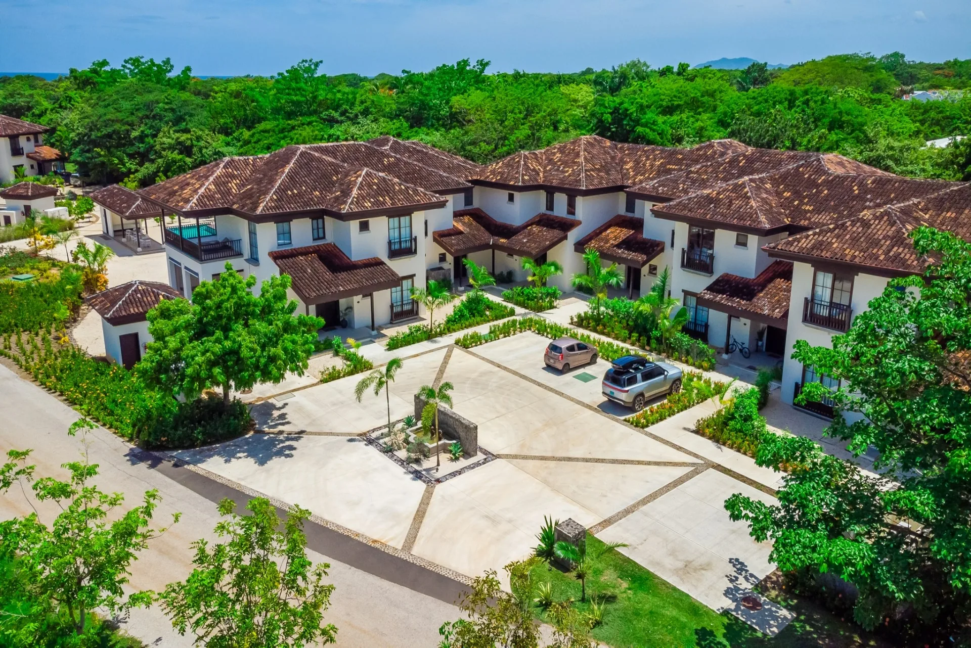 Aerial view of Lago de Palma Real residences surrounded by tropical landscaping in Hacienda Pinilla, Costa Rica.