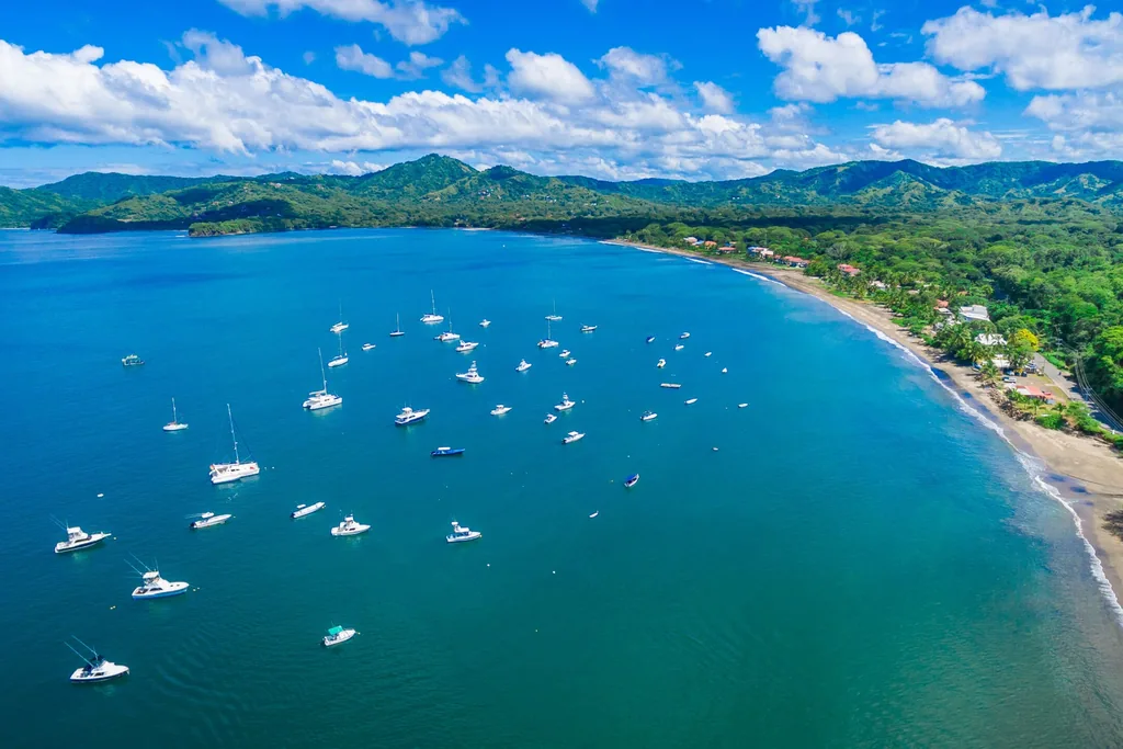 Aerial view of Playa Potrero bay with boats and coastline on Costa Rica's Guanacaste Gold Coast