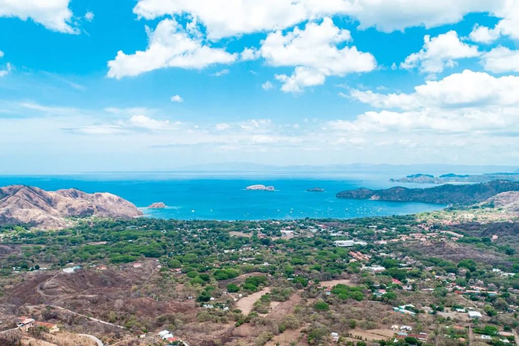 Elevated view over the Playa Flamingo area near Mar Vista, showing the coastal community, bay, and offshore islands, Guanacaste, Costa Rica