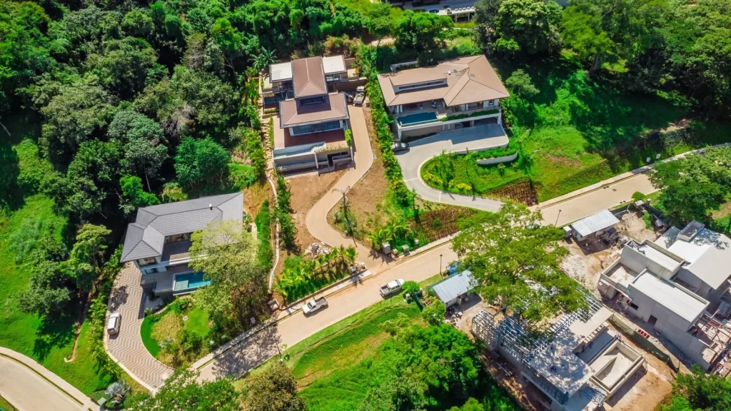 Aerial view of modern luxury homes on a forested hillside in Reserva Conchal, Costa Rica