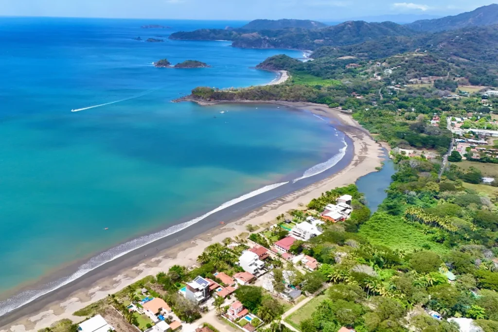 Aerial view of Surfside homes along Playa Potrero and the curve of Potrero Bay, Guanacaste, Costa Rica