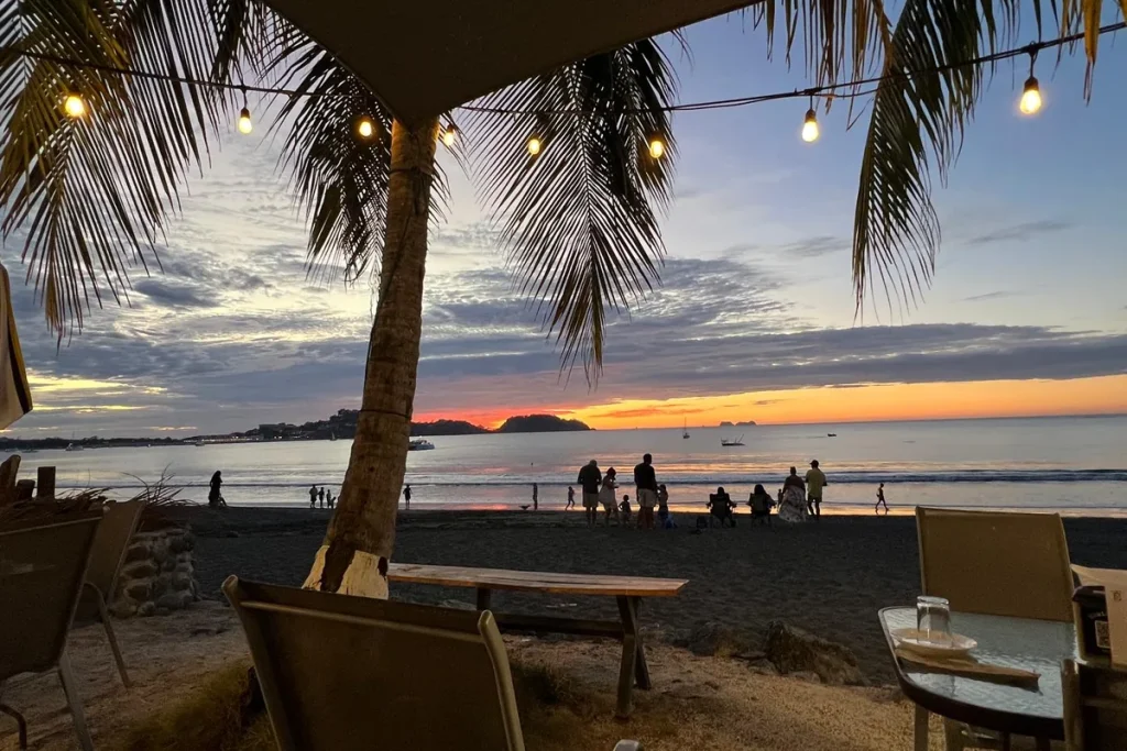 Beachfront sunset dining on Playa Potrero, looking across the bay toward Playa Flamingo, Guanacaste, Costa Rica