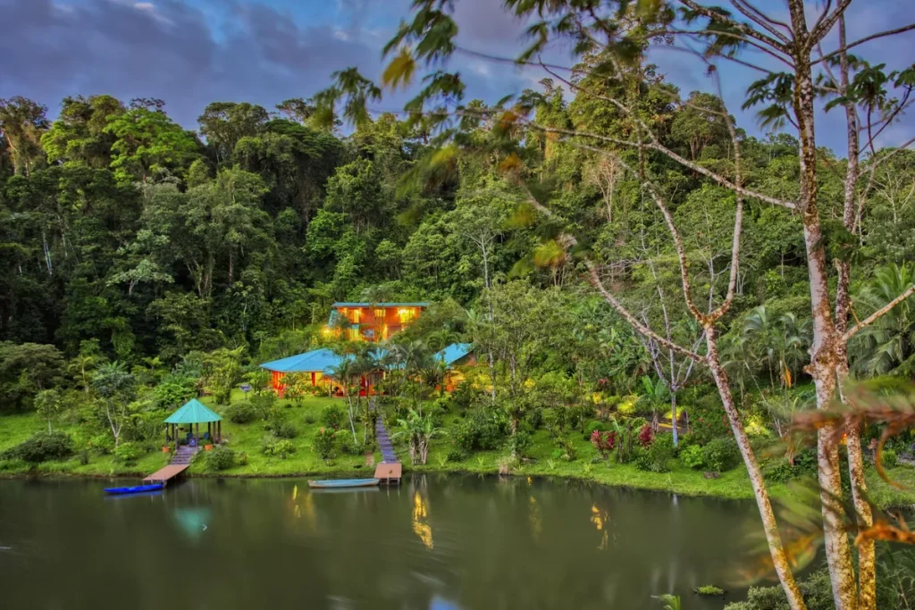Lakefront property with docks and gardens in the Nuevo Arenal area at dusk