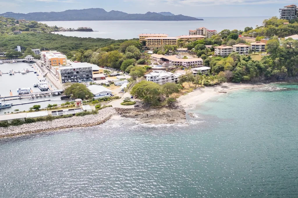 Aerial view of Playa Flamingo condos and homes above a beach cove beside the marina, Guanacaste, Costa Rica